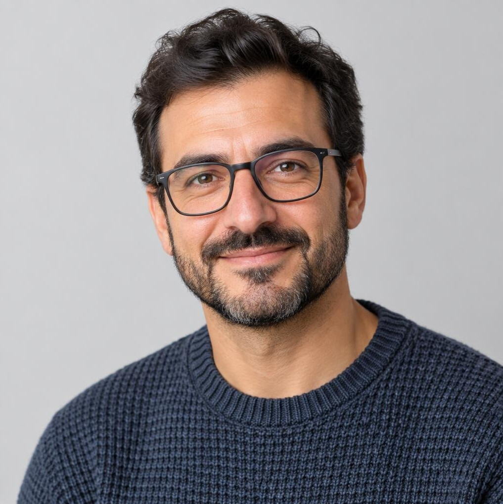Studio portrait of a man with a beard wearing glasses