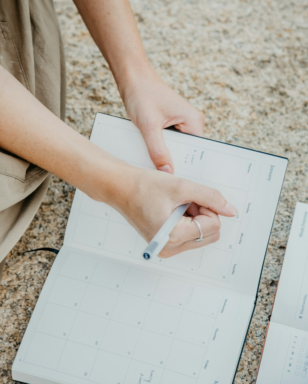 person planning schedule on calendar