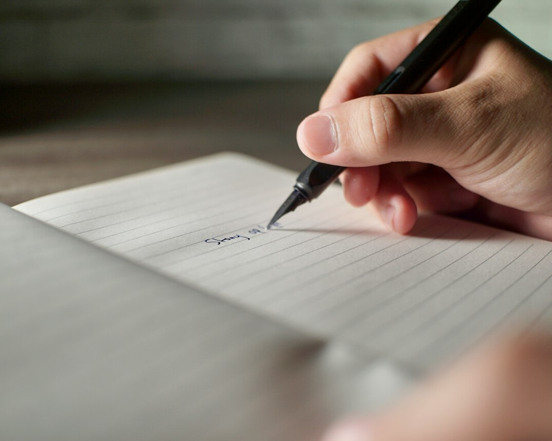 person writing to do list
