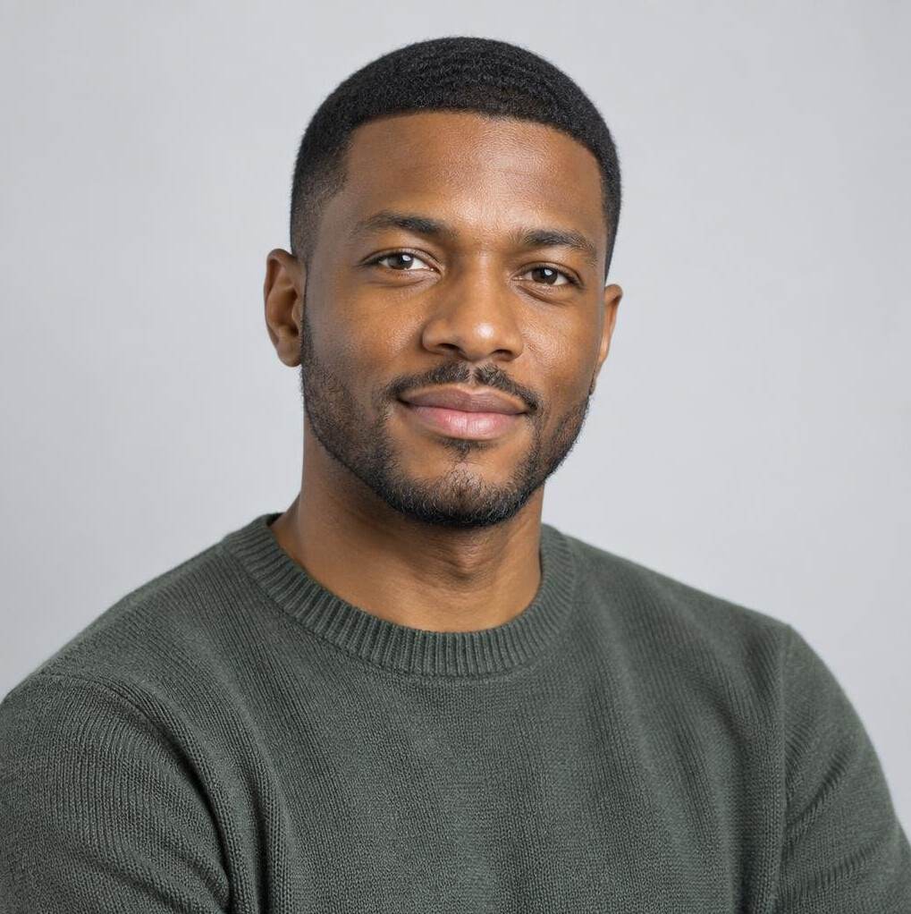 Studio portrait of a Black man in a casual sweater